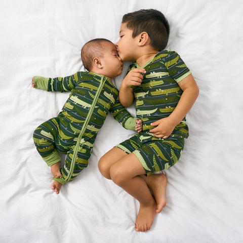 Two children wearing matching Crocodiles pajamas