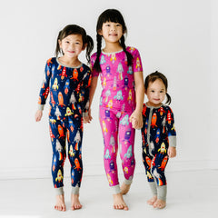 Four children sitting on the ground wearing Rad Reef and Dolphin Dance pajamas