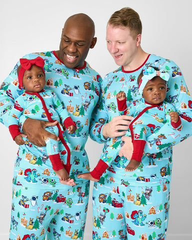 Family of four wearing Disney & Pixar Christmas Village pajamas
