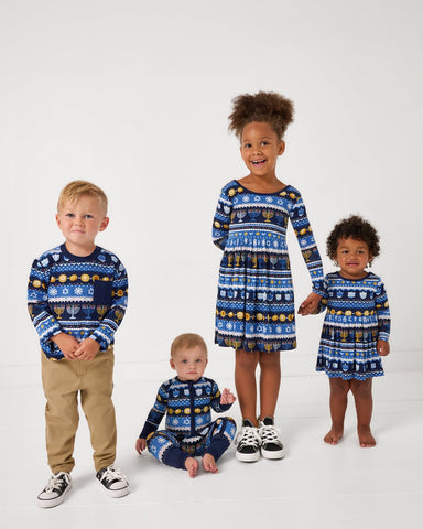 Four children wearing matching Hanukkah Fair Isle styles