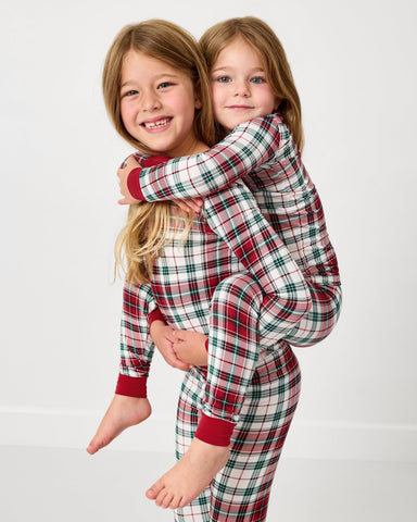 Two girls wearing matching Holly Plaid pajamas