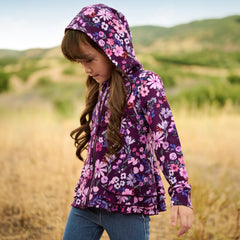 Child wearing a Violet Meadow Peplum Hoodie and Midwash Blue Denim Jeggings