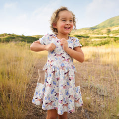 Child wearing a Wildflower Ride Patch Pocket Dress