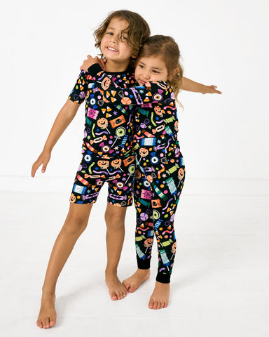 Two children wearing Halloween Haul pajama sets
