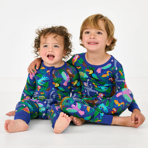 Two children wearing matching Treetop Tails pajamas
