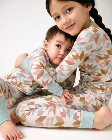 Two children wearing matching Kaleidoscope Dreams pajamas