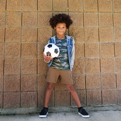 Child wearing Vintage Brown Cargo Shorts paired with a Vintage Camo tee and Denim Jacket