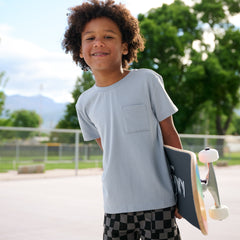 Child wearing a Fog pocket tee paired with Monochrome Check shorts