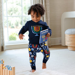 Child wearing Playful Dreidels pjs and matching Menorah Graphic Crewneck