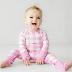 child wearing pink gingham crescent zippy
