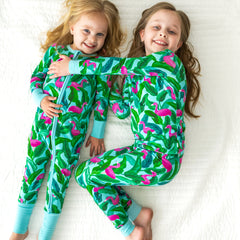 two children wearing matching Palm Springs printed pajamas