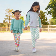 two children holding hands wearing Play by Little Sleepies leggings in Positive Vibes and Watercolor Check prints