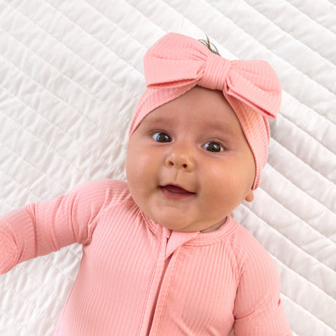 child wearing Bubblegum ribbed zippy and luxe bow headband