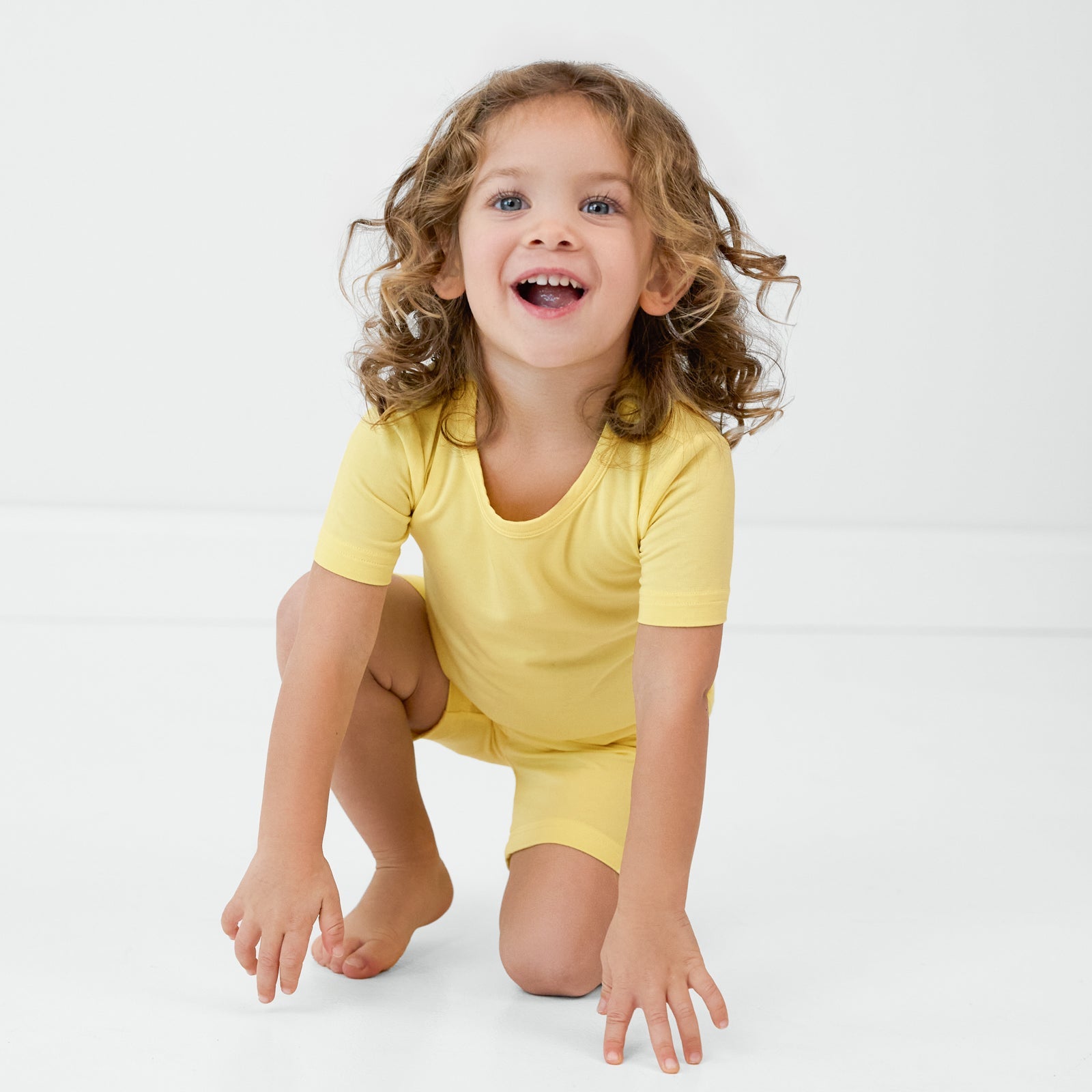 Crawling child wearing the Lemon Twist two-piece pajama set
