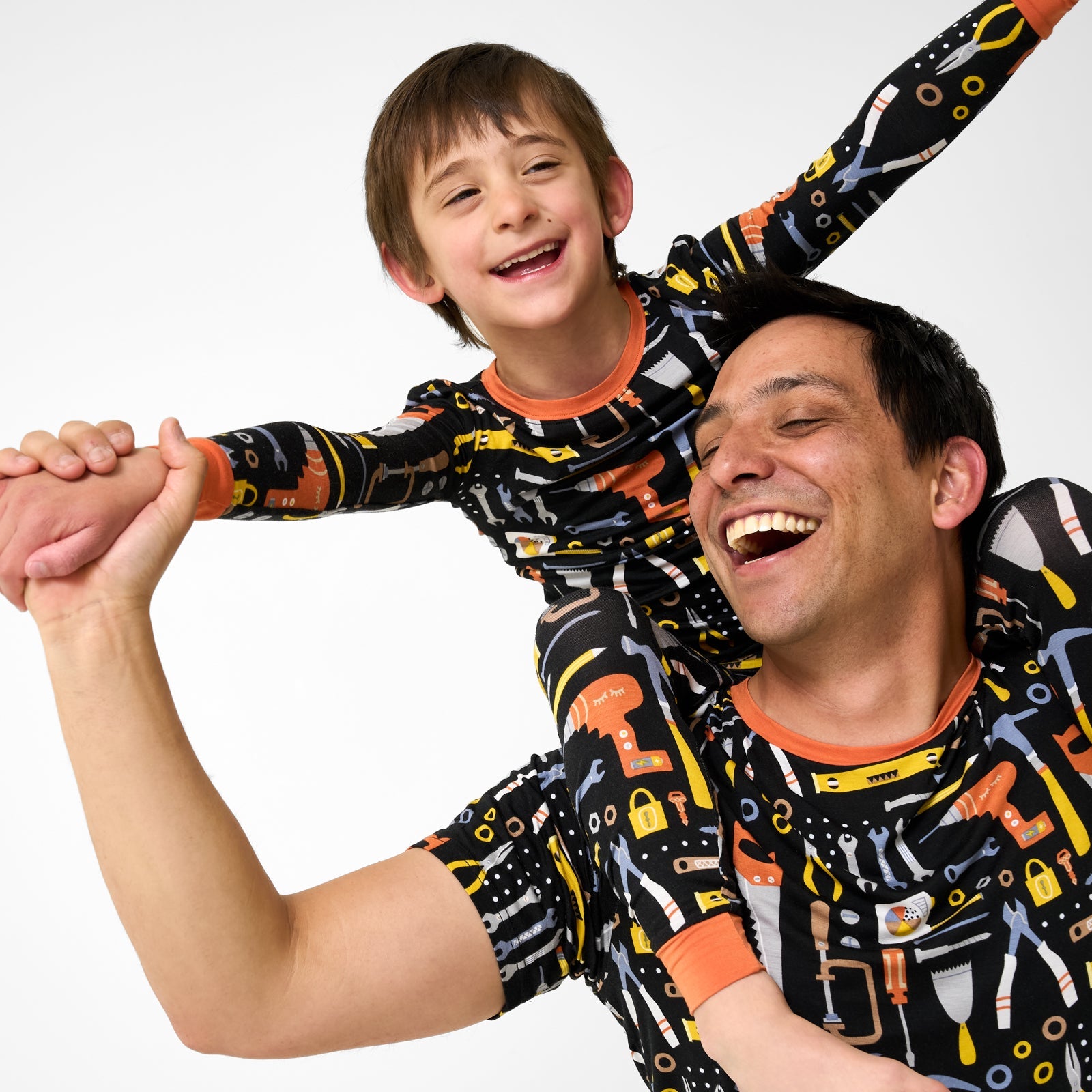 Father and son wearing matching little builders pajamas
