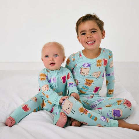 Two children wearing matching Lunch Buddies pajamas