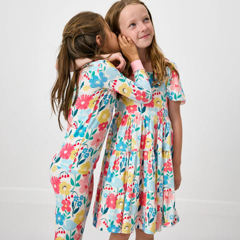 Two girls wearing floral themed clothes
