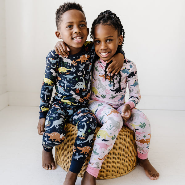 two children wearing two piece Jurassic jungle pjs