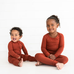 two children wearing matching Rust pj sets