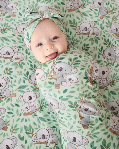Newborn baby swaddled in a Koala print blanket