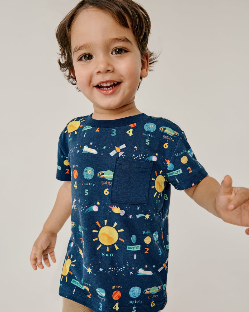 Smiling boy wearing the Solar Explorers Relaxed Pocket Tee