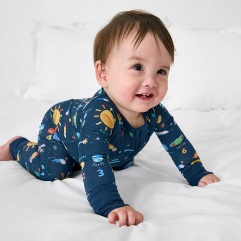 Baby wearing a space-themed zipper pj