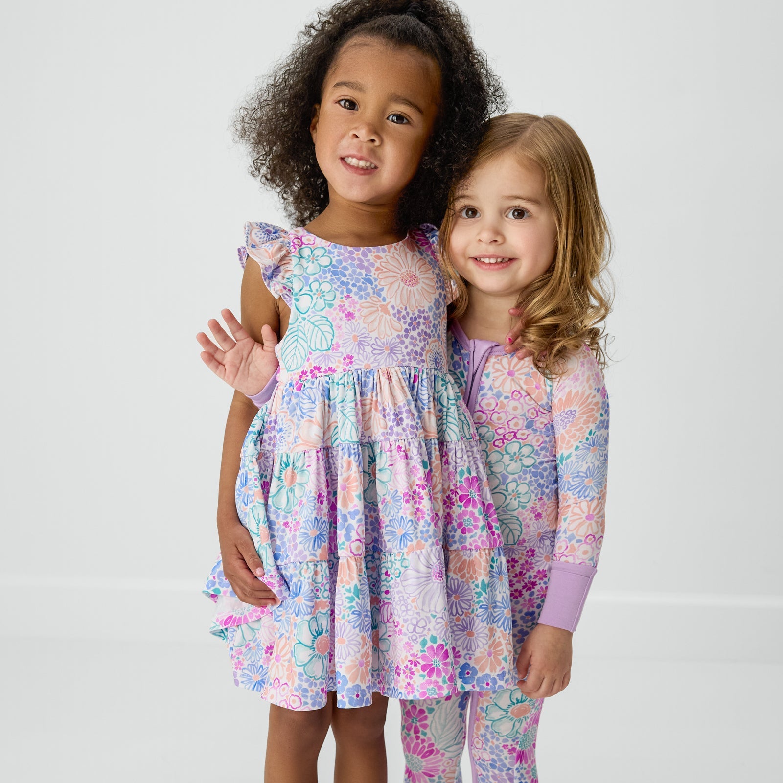 Two children wearing matching Doodle Blooms styles