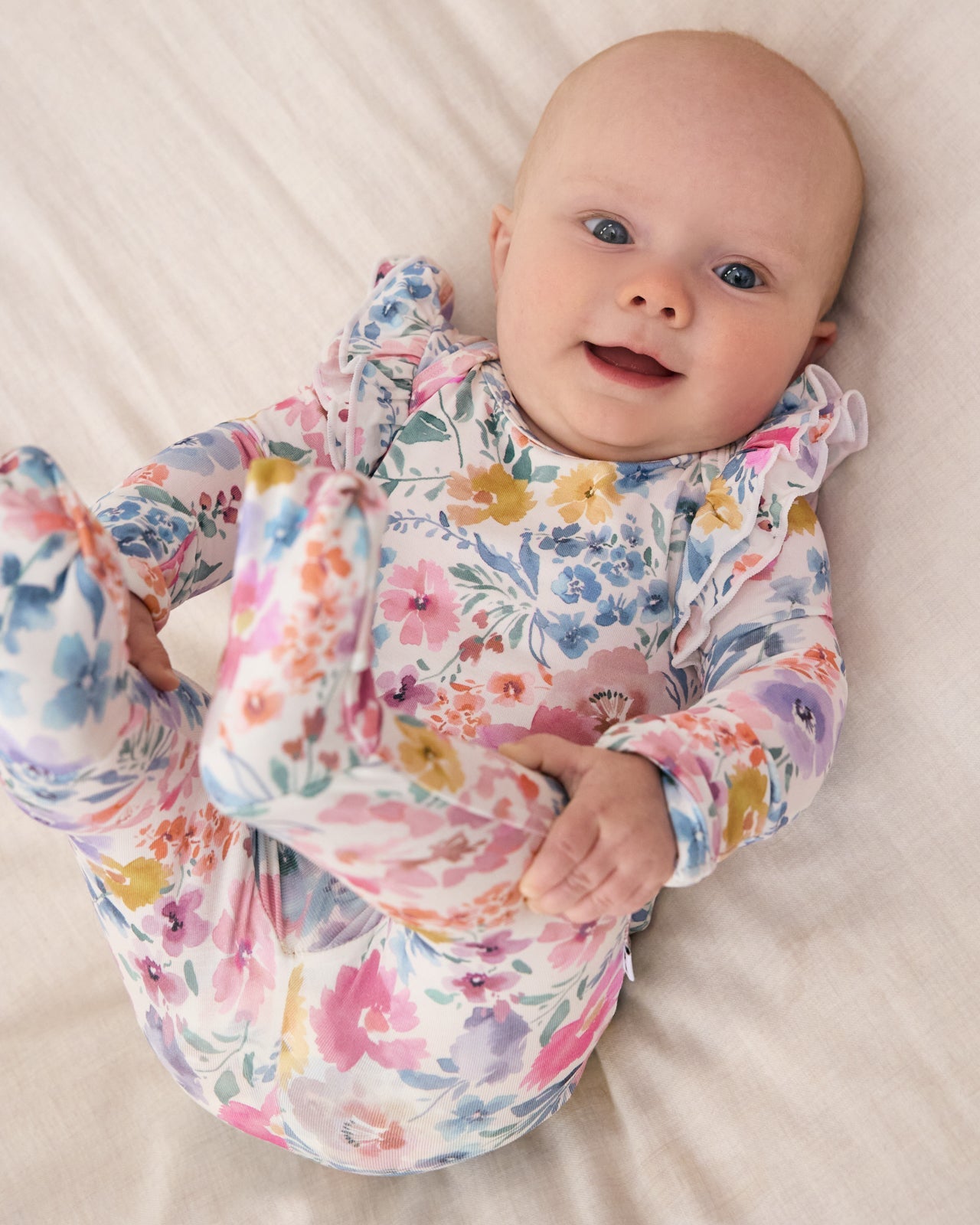 Baby girl wearing Tiny Blooms floral newborn clothing