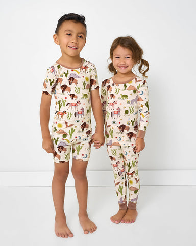 two kids wearing matching wild frontier western theme kids pajama sets