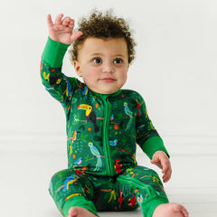 child wearing birds of a feather printed zippy pajamas.