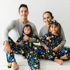 Family of four wearing matching Next Level Dinos pajama sets