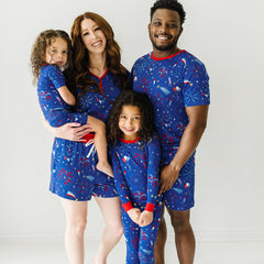 Family matching with mom, dad, and siblings in Firecracker printed bamboo viscose pajamas.