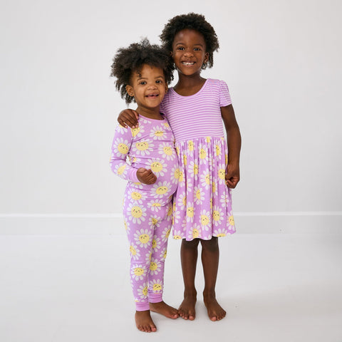 Two children wearing matching Flower Power sleep and play styles