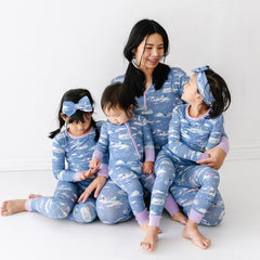 Mother and three daughters posing together wearing matching Ice Princess pajamas
