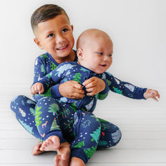 siblings wearing matching Blue Merry and Bright pajamas