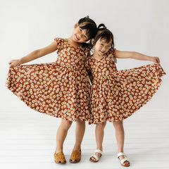 Two girls wearing Mocha Blossoms Flutter Twirl Dresses