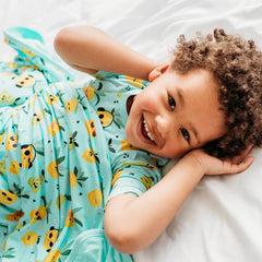Child in Pineapple Jams printed pajamas and matching Large Cloud Blanket