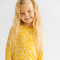 Child in Golden Poppies pajamas.