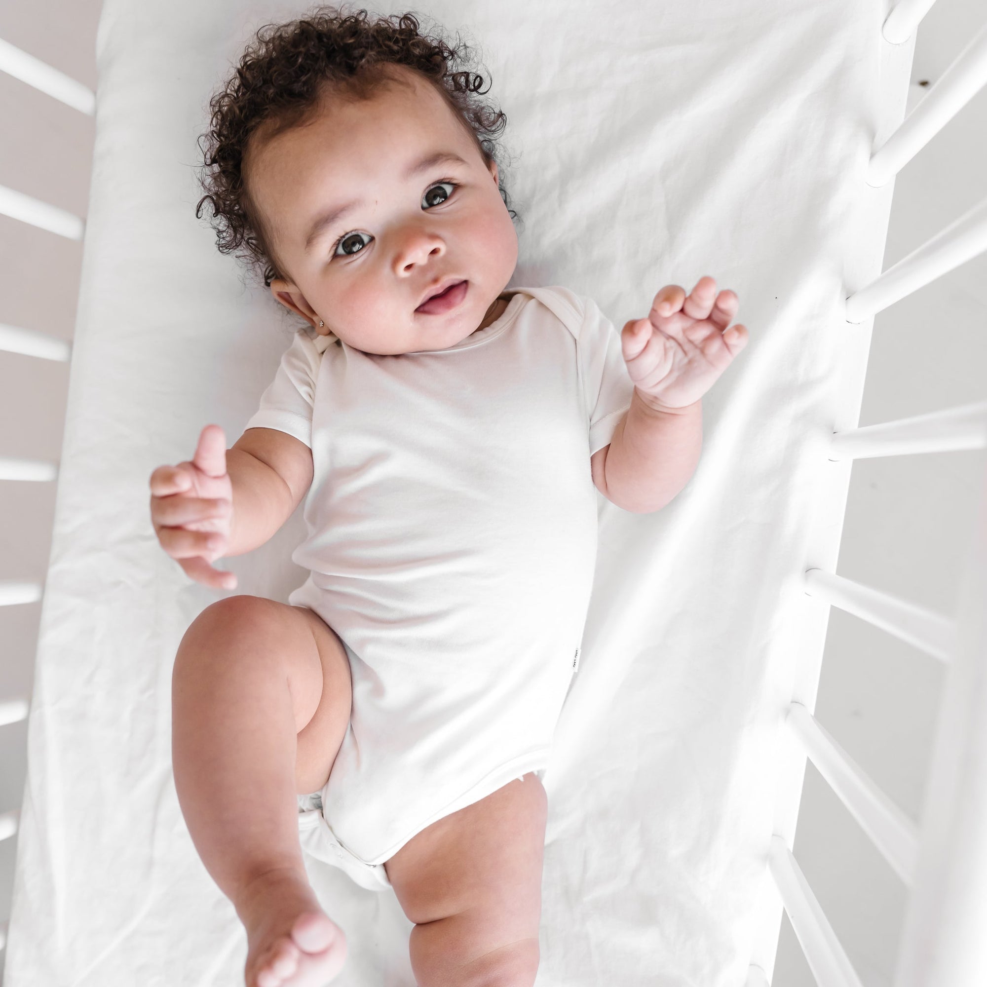 Child in White Short Sleeve Bodysuit