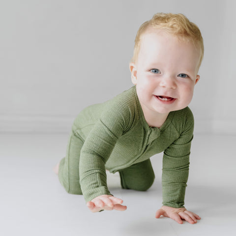 child wearing a Heather Cypress Green Ribbed zippy