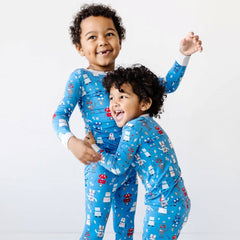 Image of two toddler boys wearing Robot Party printed pajamas in two piece long sleeve and pant sets.