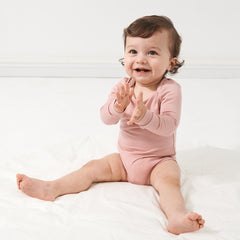 Child wearing a Mauve Blush bodysuit