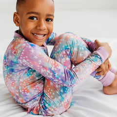 child wearing two piece pajama set in Stardust print