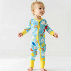 Baby in Sun Showers zippy pajamas with matching Sun Showers Sleepyhead Lovey.