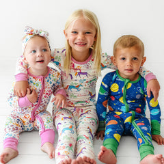 Children wearing Unicorn Magic, Rainbow Leopard, and Sleepy Galaxy printed pajamas