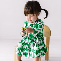 Child in quarter sleeve twirl dress with bodysuit in Watercolor Clovers print