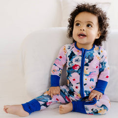 Image of a baby girl wearing a long sleeve zipper pajama 