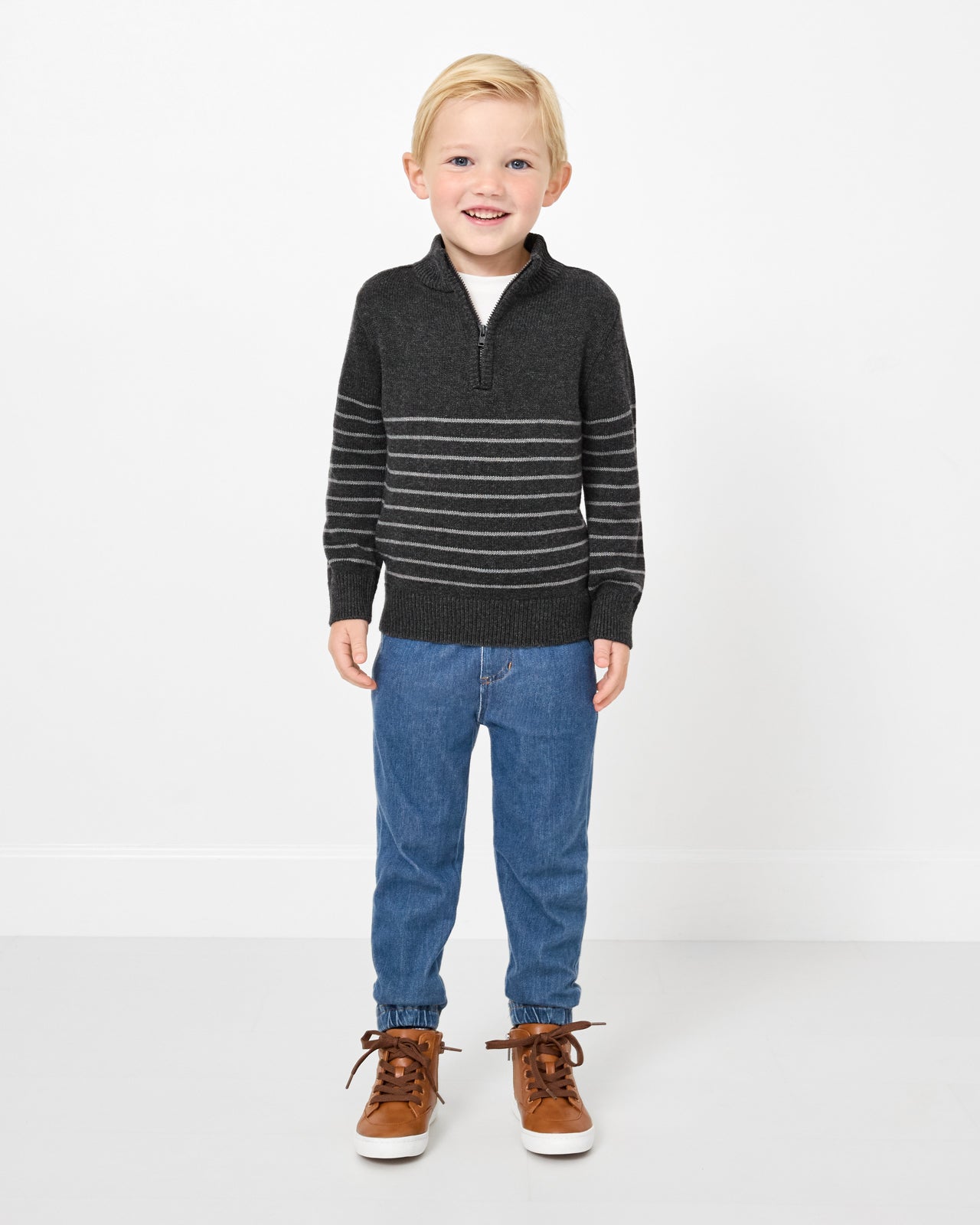 Boy wearing the Charcoal Stripes Zip Sweater with denim joggers