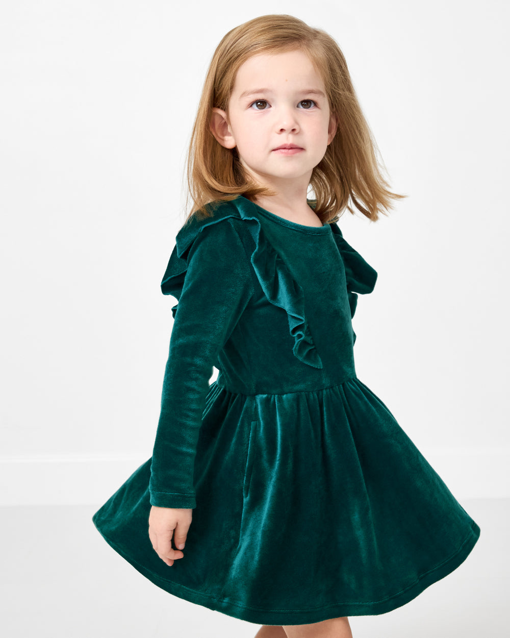 Girl wearing the Emerald Velvet Easy Fit Flutter Dress