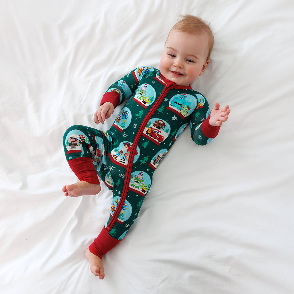 Top view image of smiling baby laying down while wearing the Disney A Very Pixar Christmas Zippy